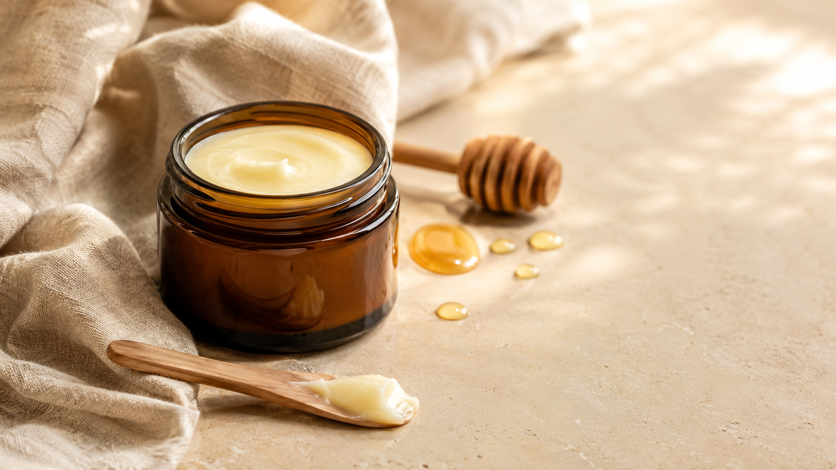 Open amber jar of pale beef tallow and honey balm with wooden spatula